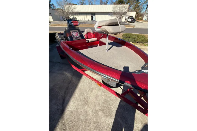 Slide: The Image of Red 1998 Fisher F 17 Pro boat with seating, parked outdoors. - 2