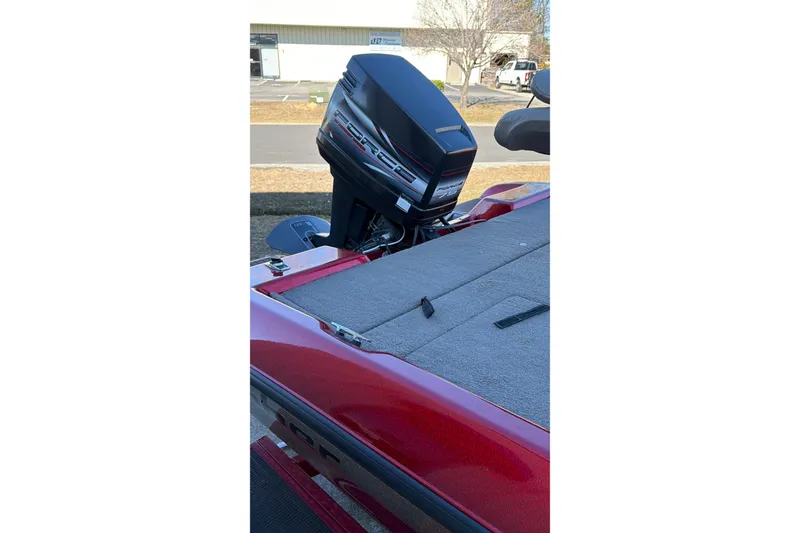 Slide: The Image of Red 1998 Fisher F 17 Pro boat with Force outboard motor in a parking lot. - 22