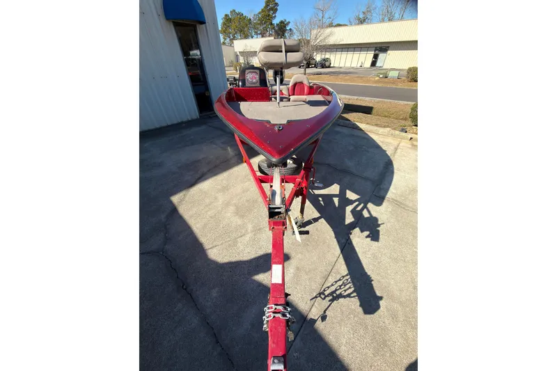 Slide: The Image of Red 1998 Fisher F 17 Pro boat on trailer, parked outside a building. - 3