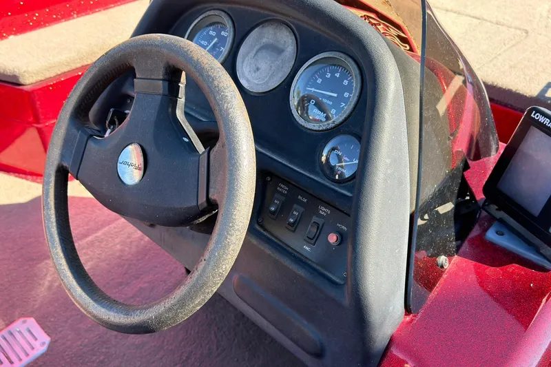 Slide: The Image of Steering console of a 1998 Fisher F 17 Pro boat with gauges and controls. - 9