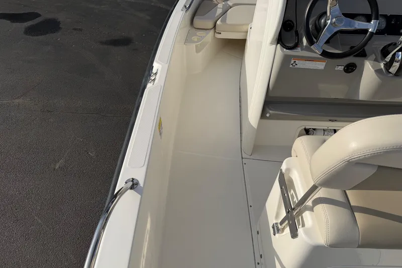 Slide: The Image of 2017 Boston Whaler 210 Dauntless boat interior with steering wheel and seating. - 11