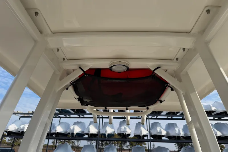 Slide: The Image of 2017 Boston Whaler 210 Dauntless T-top with storage net and light fixture. - 17