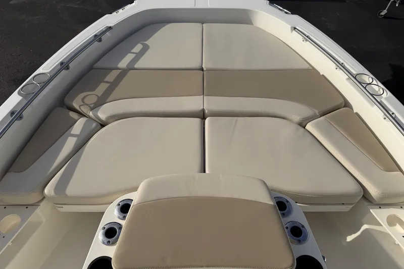 Slide: The Image of 2017 Boston Whaler 210 Dauntless boat with beige cushioned seating and cup holders. - 5