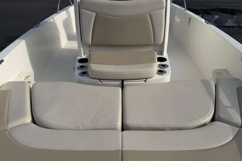 Slide: The Image of 2017 Boston Whaler 210 Dauntless boat interior with beige seating and cup holders. - 6