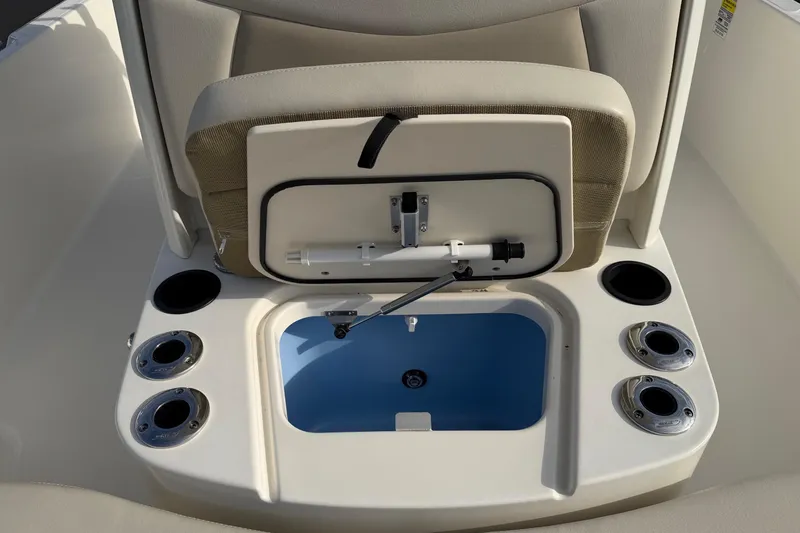 Slide: The Image of 2017 Boston Whaler 210 Dauntless boat interior with open storage compartment and cup holders. - 7