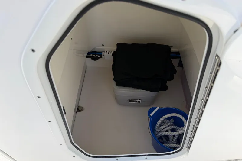 Slide: The Image of Storage compartment in a 2017 Boston Whaler 210 Dauntless with rope and container. - 8