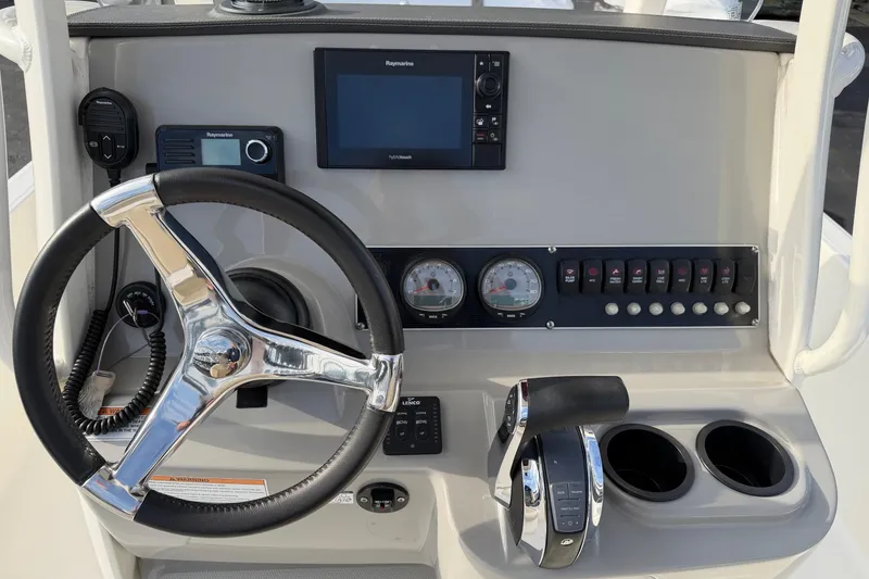 Slide: The Image of Control panel of a 2017 Boston Whaler 210 Dauntless boat with steering wheel and gauges. - 9