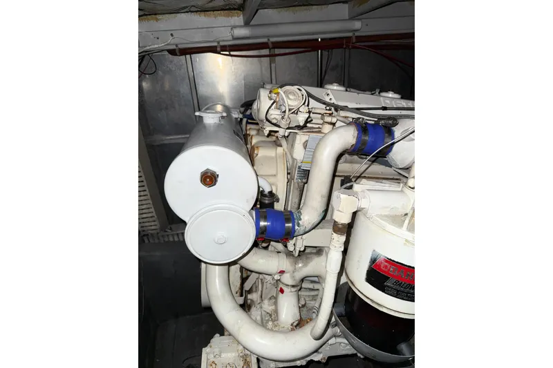 Slide: The Image of Engine compartment of 1989 Silverton 46 Aft Cabin boat, showcasing mechanical components. - 12