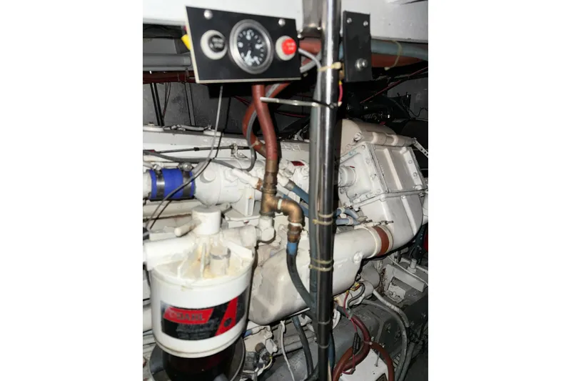 Slide: The Image of Engine room of 1989 Silverton 46 Aft Cabin yacht, featuring mechanical components and gauges. - 13