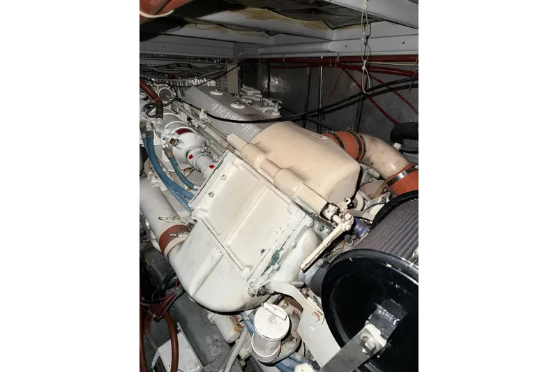 Slide: The Image of Engine compartment of a 1989 Silverton 46 Aft Cabin boat, showcasing mechanical components. - 14