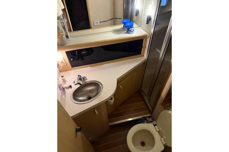 Slide: The Image of 1989 Silverton 46 Aft Cabin bathroom with sink, mirror, and toilet. - 6