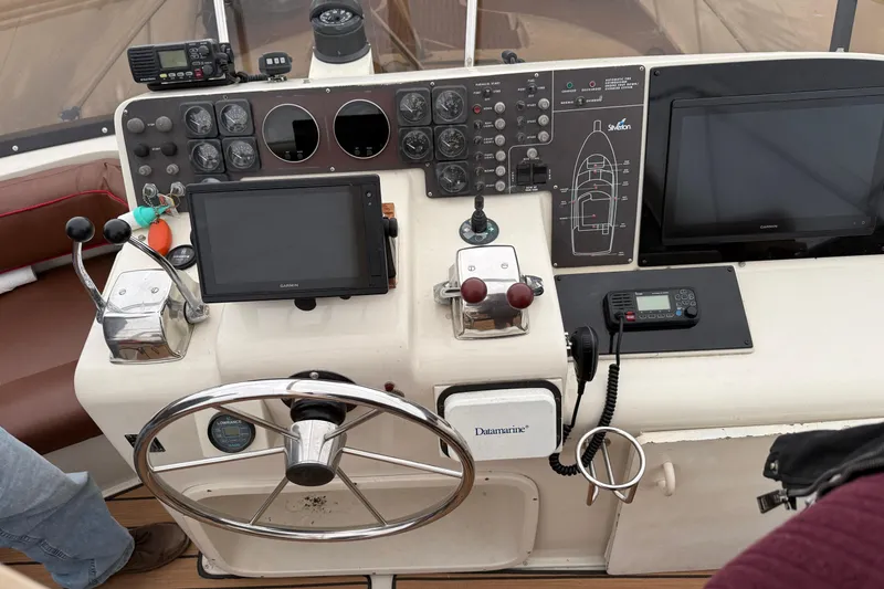 Slide: The Image of 1989 Silverton 46 Aft Cabin helm with navigation equipment and steering wheel. - 9