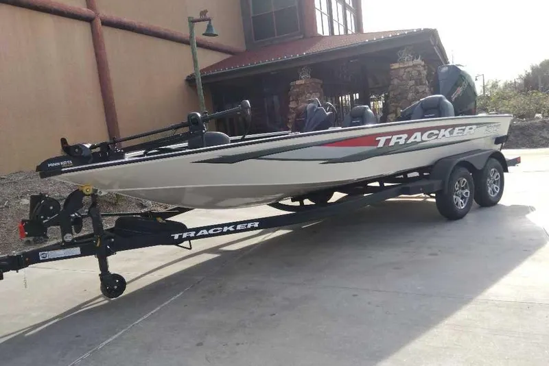 The Image of 2026 Tracker Savage 215 boat on trailer, parked outside a building. - 0