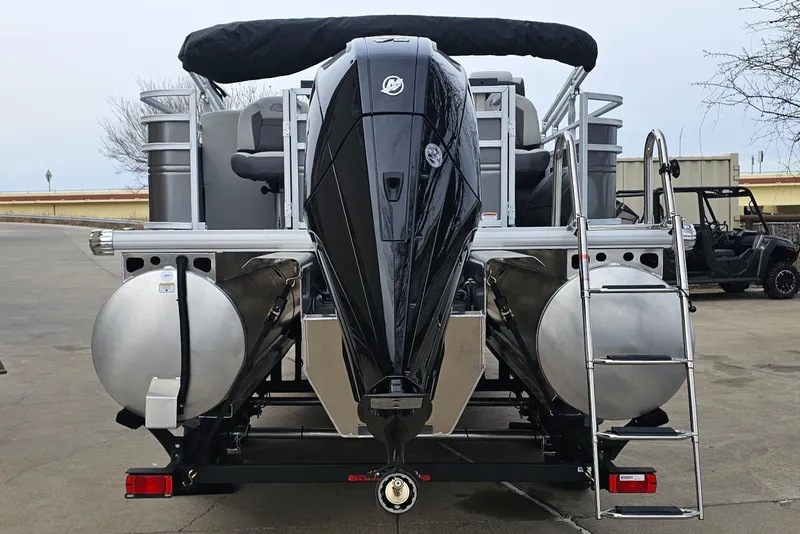 Slide: The Image of 2026 Sun Tracker Fishin' Barge 22 XP3 pontoon boat, rear view with motor and ladder. - 6