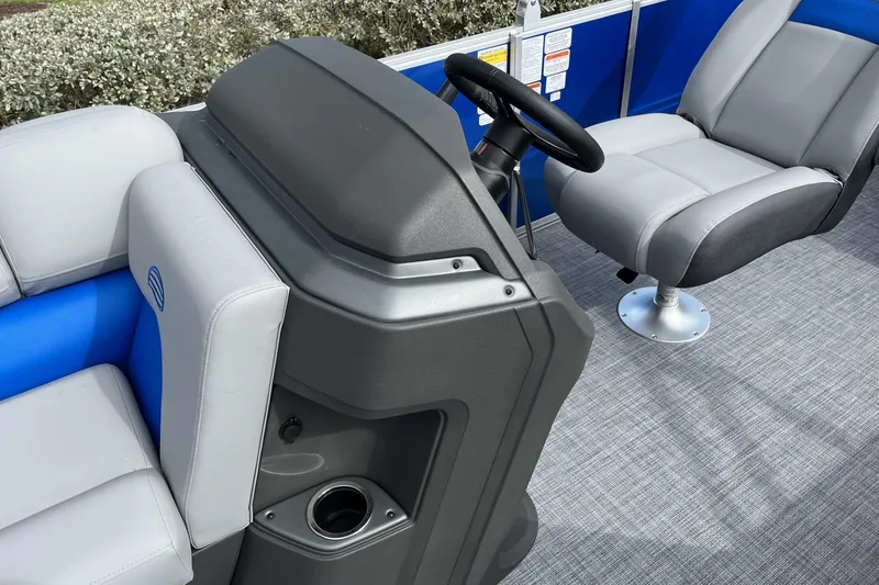 Slide: The Image of 2026 Sun Tracker Party Barge 20 DLX interior with steering console and seating. - 100