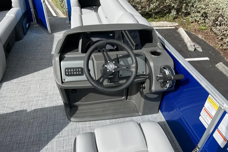 Slide: The Image of 2026 Sun Tracker Party Barge 20 DLX helm with steering wheel and controls. - 104