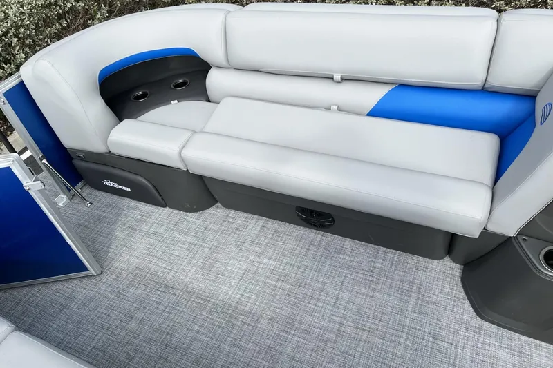 Slide: The Image of 2026 Sun Tracker Party Barge 20 DLX interior with gray and blue seating. - 99