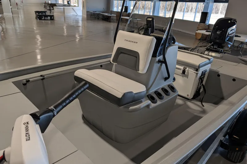 Slide: The Image of 2026 Tracker Bass Tracker Classic CC boat interior with seating and equipment in a showroom. - 58
