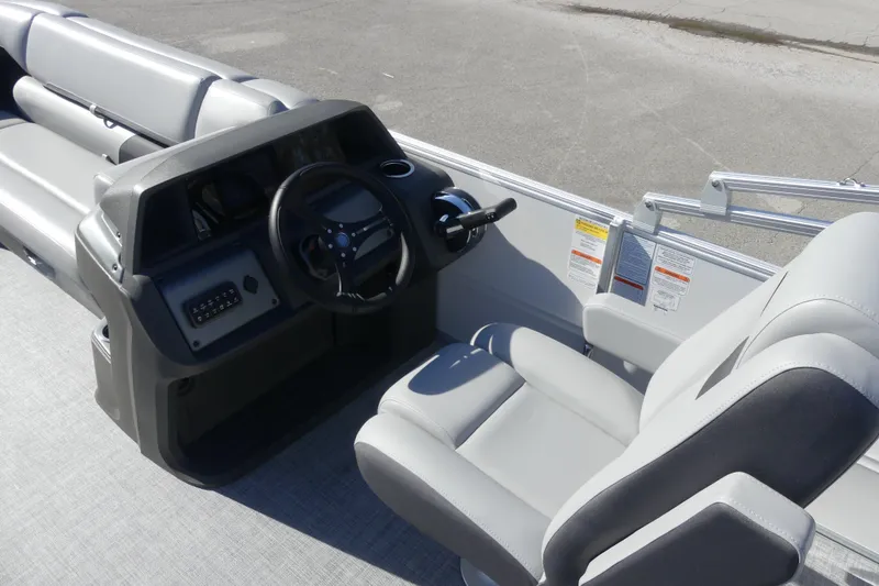 Slide: The Image of 2026 Sun Tracker Party Barge 20 DLX interior with steering console and seating. - 19