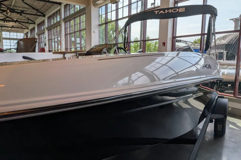 The Image of 2026 Tahoe T18 boat displayed indoors with large windows and sleek design. - 0