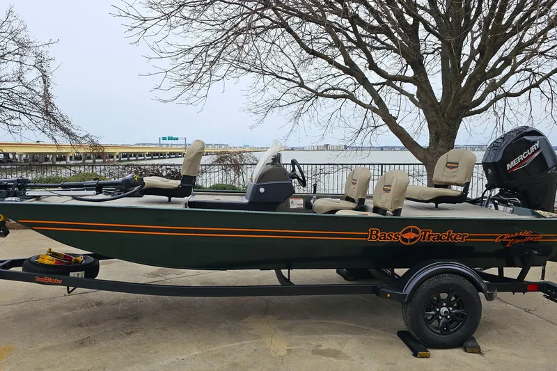 The Image of 2026 Tracker Bass Tracker Classic Limited boat on trailer by waterfront. - 0