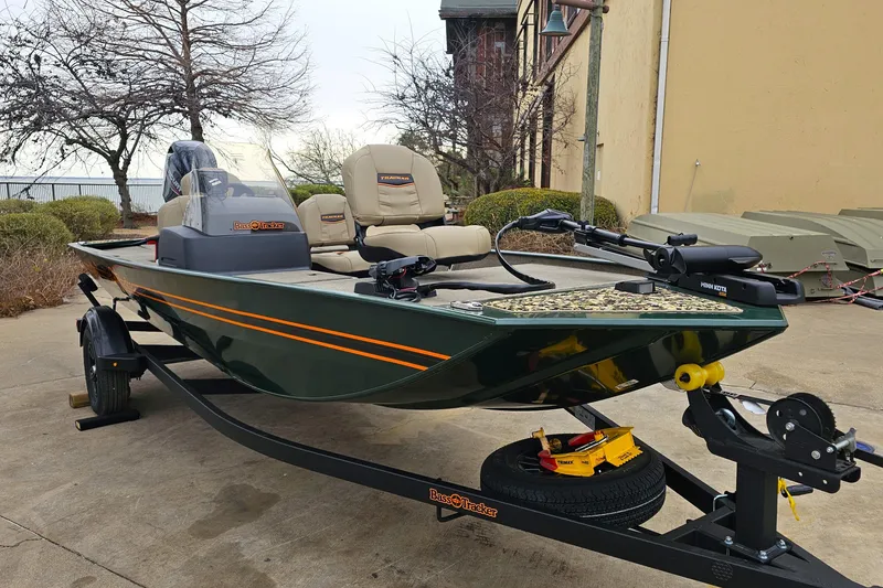 Slide: The Image of 2026 Tracker Bass Tracker Classic Limited boat on trailer, parked outdoors. - 2