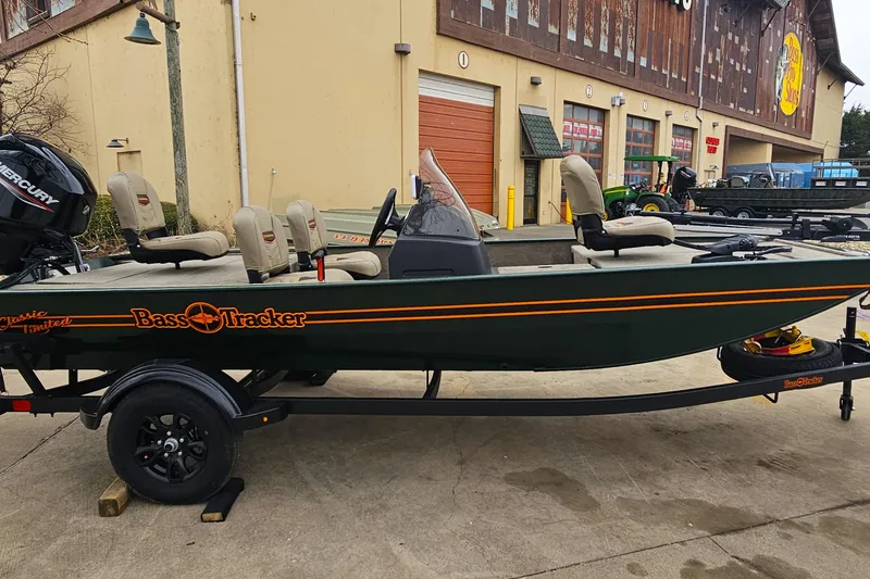 Slide: The Image of 2026 Tracker Bass Tracker Classic Limited boat on trailer outside a store. - 3