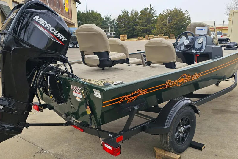 Slide: The Image of 2026 Tracker Bass Tracker Classic Limited boat with Mercury engine, parked outdoors. - 4