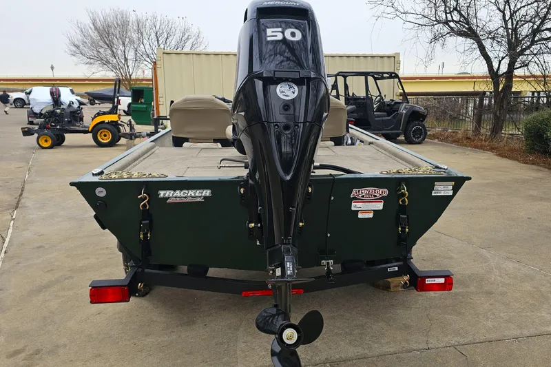 Slide: The Image of 2026 Tracker Bass Tracker Classic Limited boat with Mercury 50 engine, parked outdoors. - 5