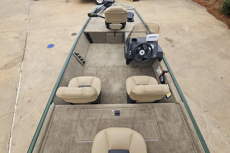 Slide: The Image of 2026 Tracker Bass Tracker Classic Limited boat interior with beige seats and steering console. - 8