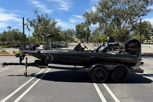 Slide: The Image of 2026 Nitro Z18 Pro boat in parking lot, sleek black design, dual-axle trailer. - 3
