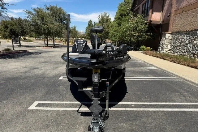 Slide: The Image of 2026 Nitro Z18 Pro boat parked in a sunny lot, surrounded by trees and buildings. - 1