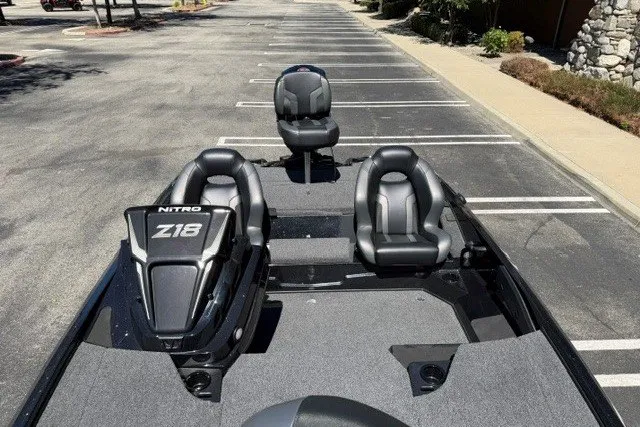 Slide: The Image of 2026 Nitro Z18 Pro boat with sleek seating and modern design in a parking lot. - 9