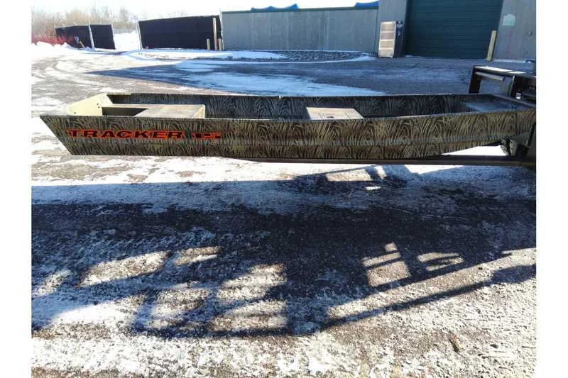 The Image of 2026 Tracker Grizzly 15 Jon boat on a snowy outdoor surface. - 0