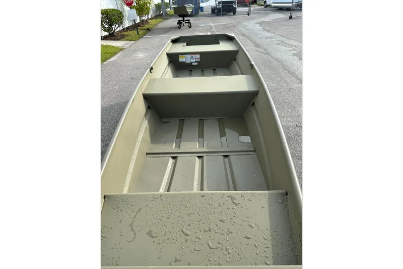 Slide: The Image of 2026 Tracker Grizzly 12 Jon boat interior with water droplets on the floor. - 3