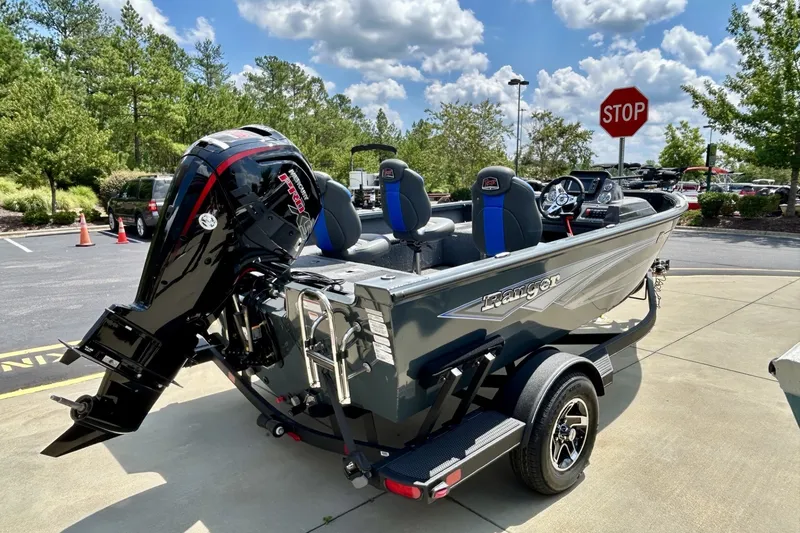 Slide: The Image of 2026 Ranger VS1682SC Angler boat with powerful outboard motor in a sunny parking lot. - 5