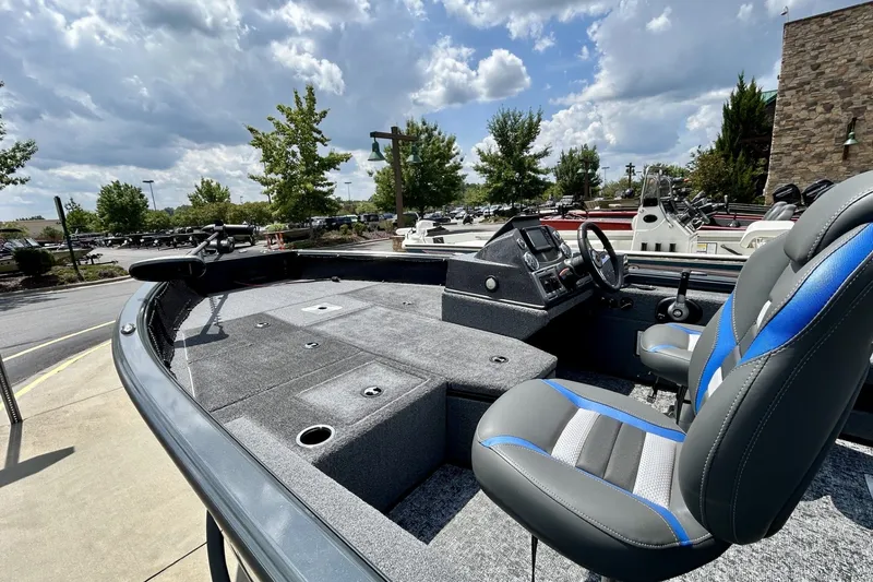 Slide: The Image of 2026 Ranger VS1682SC Angler boat with modern seating and control panel under cloudy sky. - 6