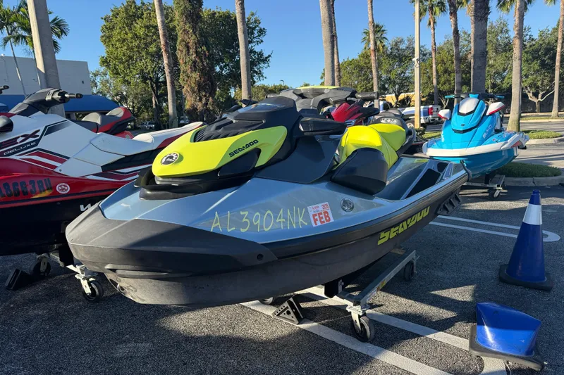 Slide: The Image of 2021 Sea-Doo GTI SE 130 jet ski parked outdoors with other watercraft. - 2