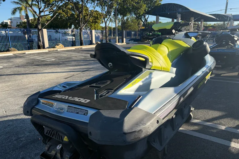 Slide: The Image of 2021 Sea-Doo GTI SE 130 jet ski in parking lot, vibrant yellow seat. - 4