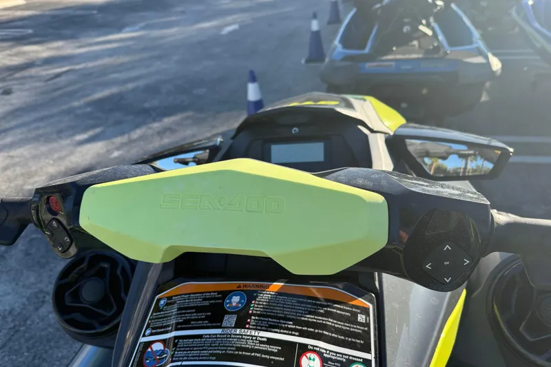 Slide: The Image of 2021 Sea-Doo GTI SE 130 handlebars with control panel, parked outdoors. - 7