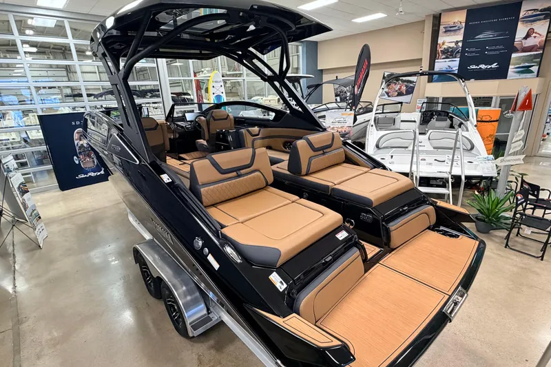Slide: The Image of 2026 Yamaha Boats 275SD in showroom, featuring luxurious tan seating and sleek design. - 3