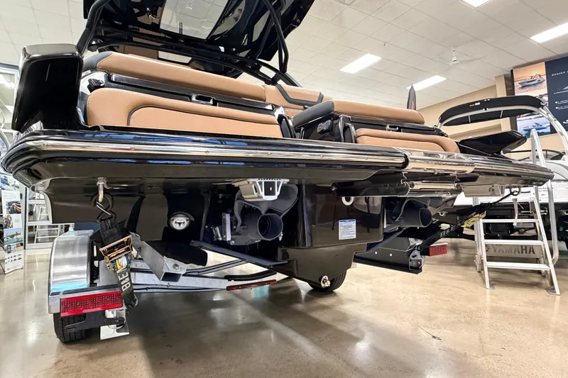 Slide: The Image of 2026 Yamaha Boats 275SD rear view in showroom, showcasing sleek design and dual exhaust. - 4