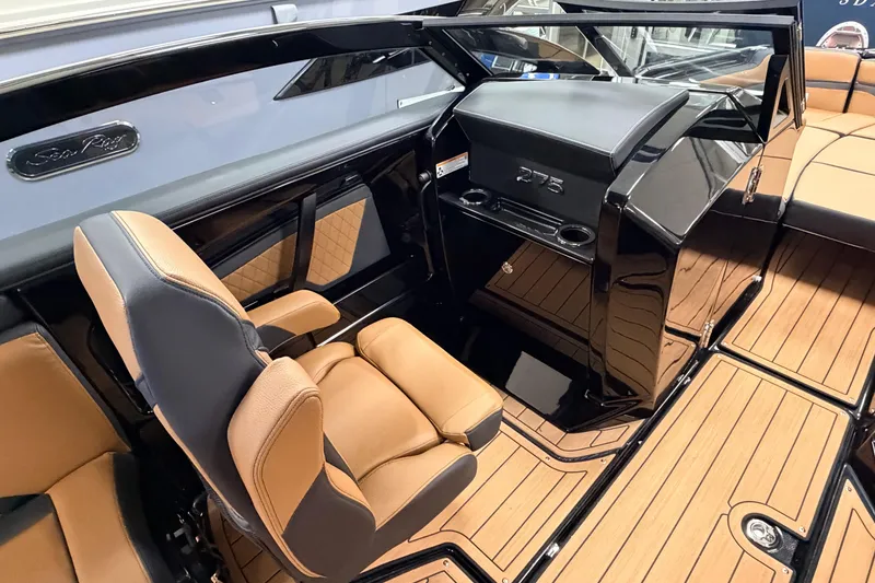 Slide: The Image of 2026 Yamaha Boats 275SD interior with tan seating and sleek black dashboard. - 6