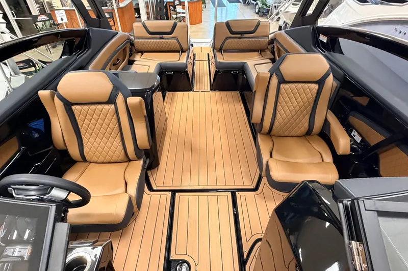 Slide: The Image of Luxurious interior of 2026 Yamaha Boats 275SD with tan leather seating and wood flooring. - 7