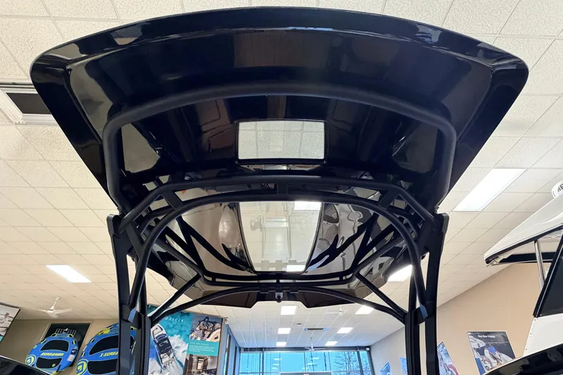 Slide: The Image of 2026 Yamaha Boats 275SD, sleek black canopy design in showroom setting. - 9