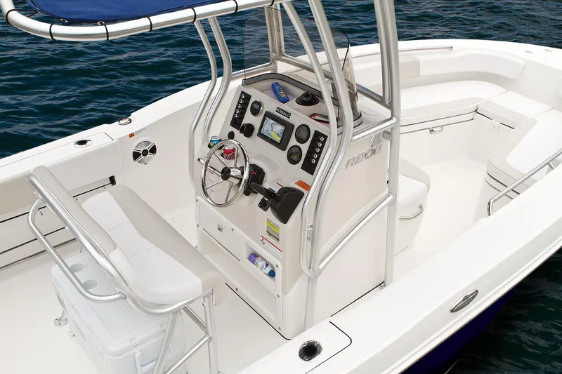 Slide: The Image of Manufacturer Provided Image: 2018 Robalo R200 Center Console boat interior with navigation controls and seating. - 12