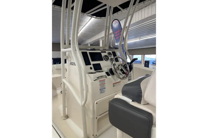 Slide: The Image of 2018 Robalo R200 Center Console boat interior with steering wheel and control panel. - 2