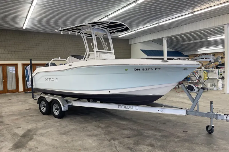Slide: The Image of 2018 Robalo R200 Center Console boat on trailer in indoor storage. - 4