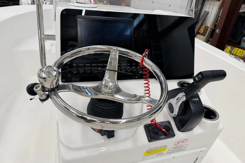 Slide: The Image of 2026 Tidewater 180 CC Adventure boat interior, featuring sleek white design and seating. - 12