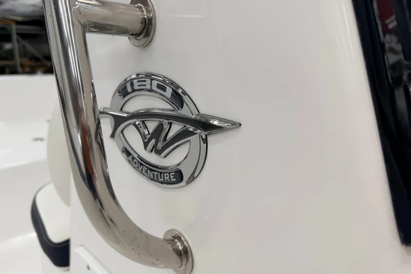 Slide: The Image of 2026 Tidewater 180 CC Adventure boat interior with Yamaha engine, featuring cushioned seating. - 14